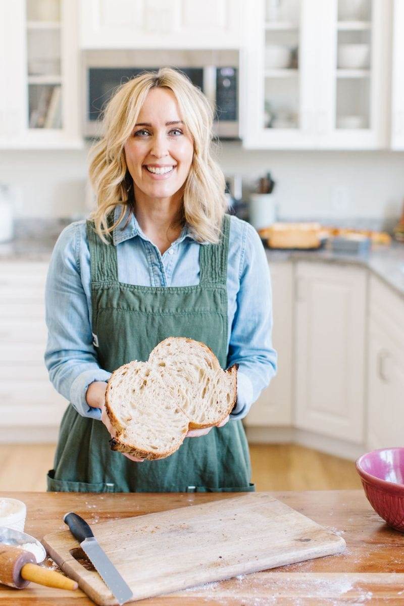 Heather Thomas, That Bread Lady, holding a loaf of sourdough bread.