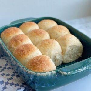Whole grain dinner rolls in a baking dish.