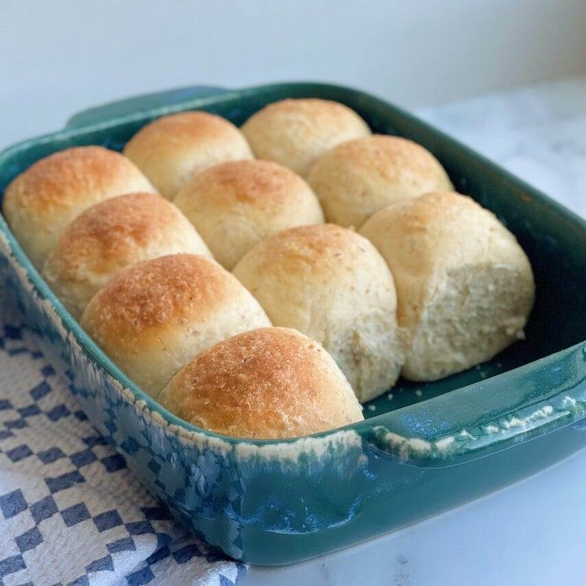 Whole grain dinner rolls in a baking dish.