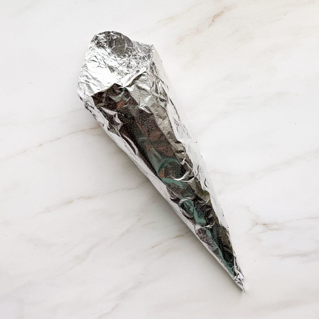 A cone mold in aluminum foil.