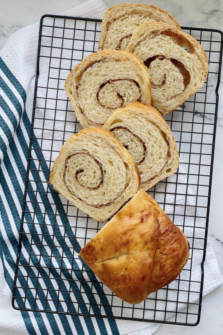 Cinnamon Swirl bread sliced on a cooling rack.