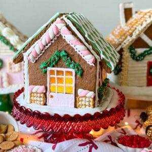 Three gingerbread houses decorated with white, green and pink icing.