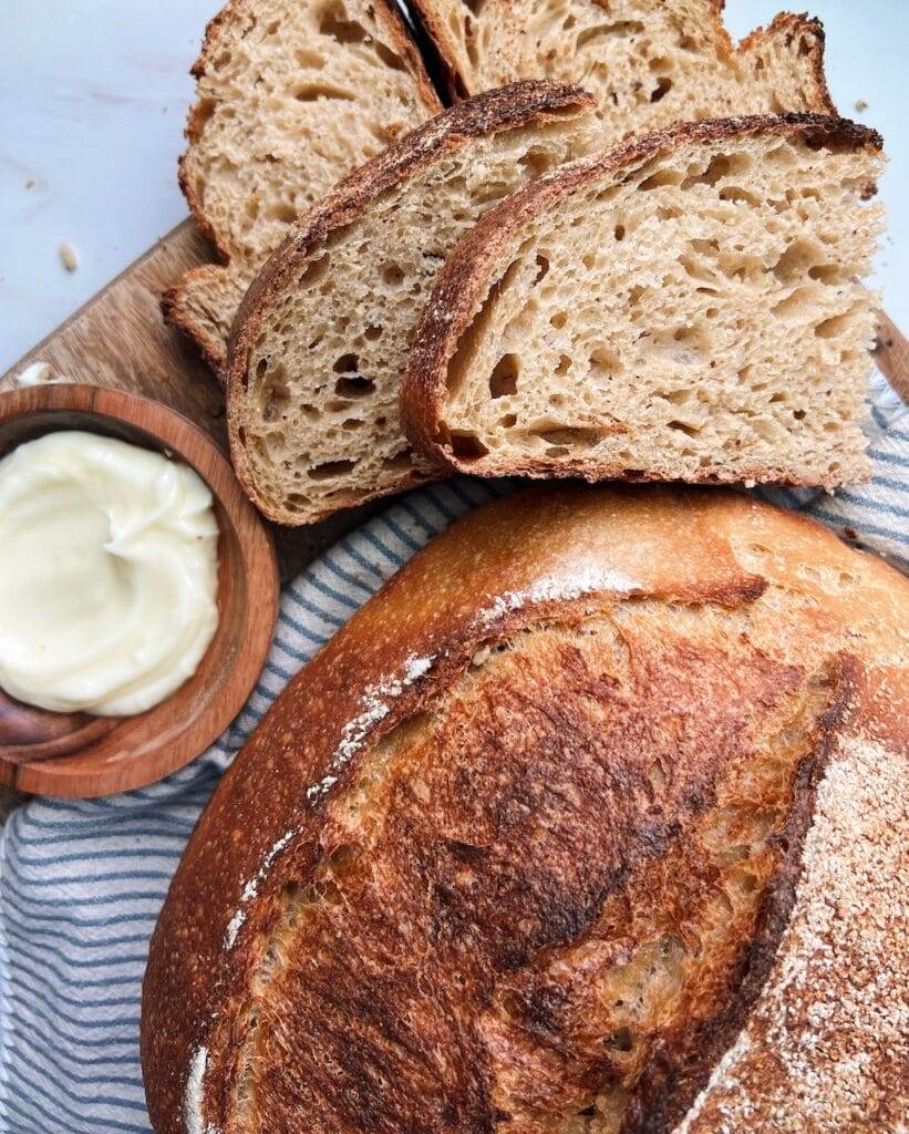 Whole grain bread sliced with butter on the side.