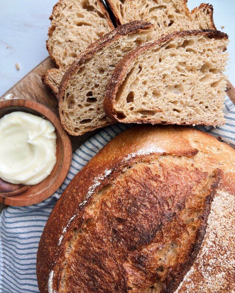 Whole grain bread sliced with butter on the side.