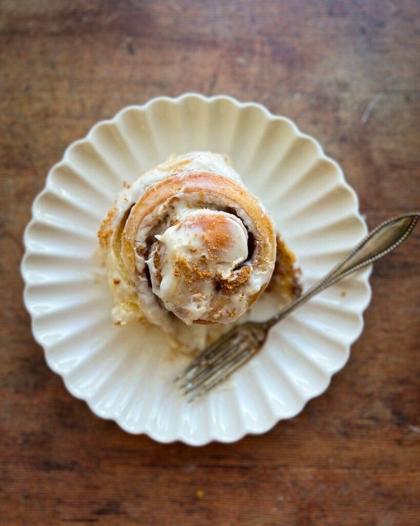 A biscoff cinnamon roll on a plate.