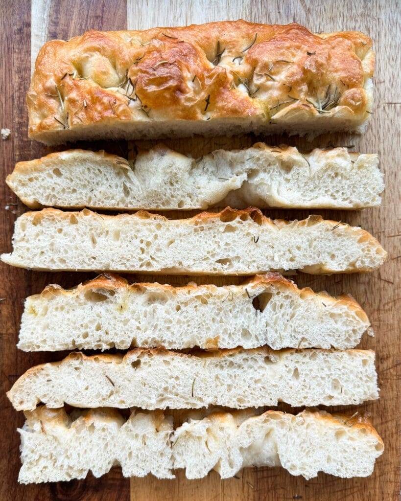 Sliced focaccia on a bread board.