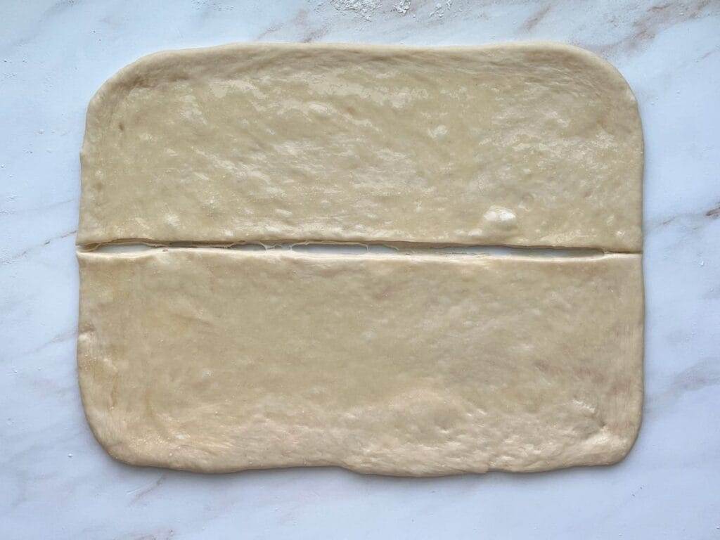Parker House Rolls dough divided in half lengthwise.