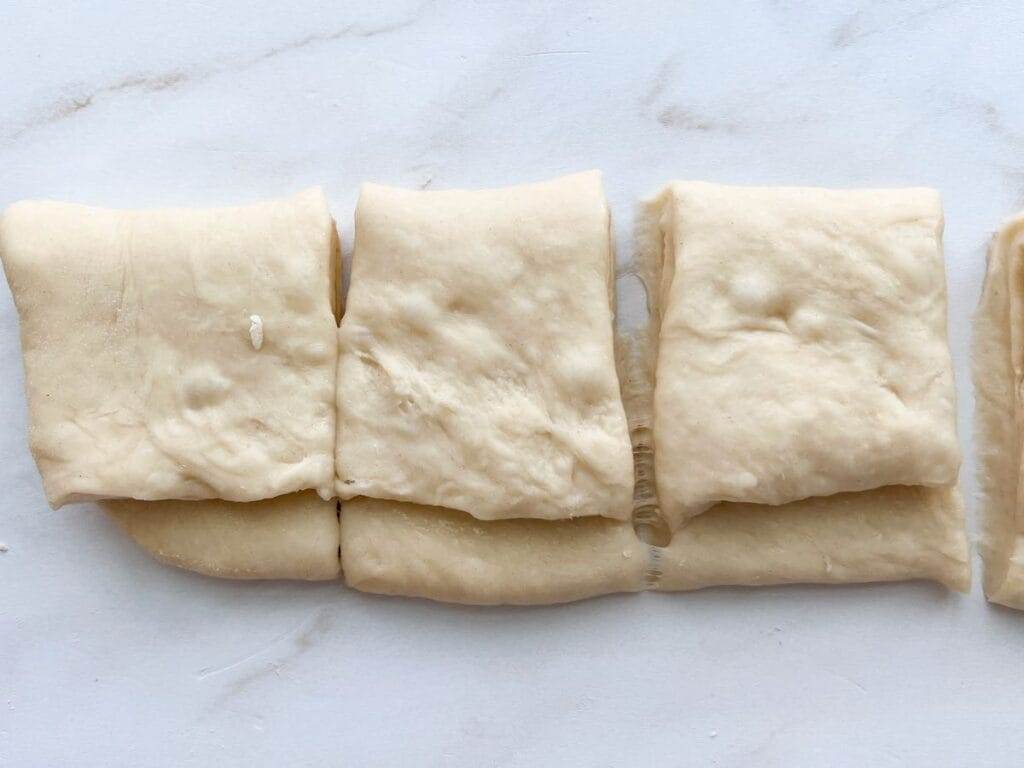 Close up of Parker House Rolls divided before baking.