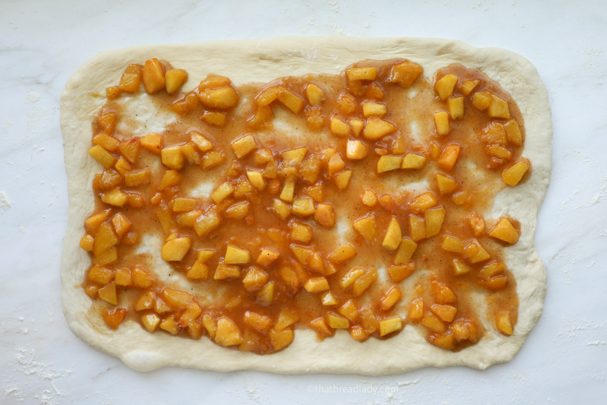 Roll dough rolled out to a rectangle, covered with peach filling.