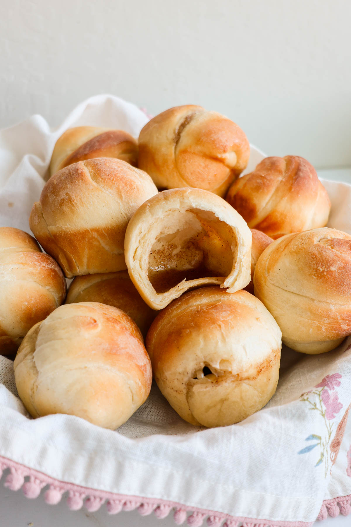 A basket full of Resurrection rolls with one open showing the hollow interior.