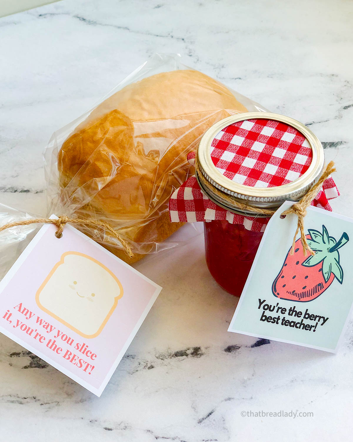 A loaf of bread with a tag that says, "any way you slice it, you're the best," and a jar of strawberry jam with a tag that says, "you're the berry best teacher."